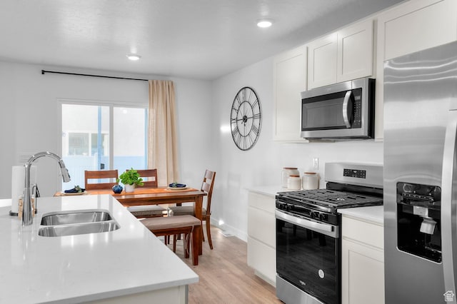 716 N 1700 E Unit 1128, Salem, UT 84653 - kitchen with white cabinetry, stainless steel appliances, sink, and light wood-type flooring