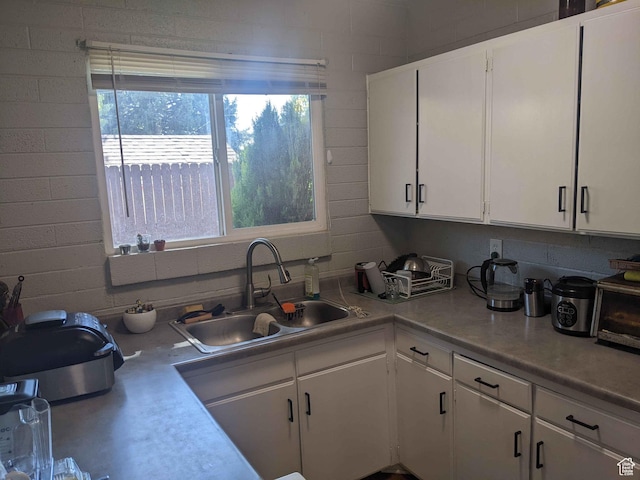 173 N K St E, Salt Lake City, UT 84103 - kitchen featuring white cabinetry and sink