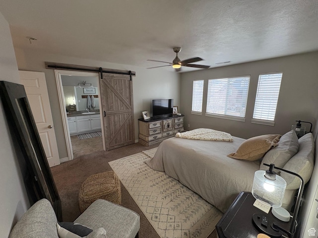 840 N Great View Dr E, Morgan, UT 84050 - carpeted bedroom featuring a barn door, ensuite bath, and ceiling fan