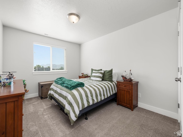 bedroom featuring baseboards, visible vents, and light colored carpet