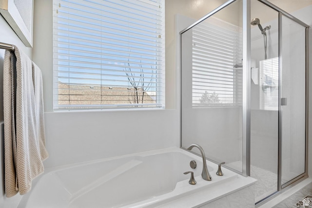 full bathroom with a garden tub and a shower stall