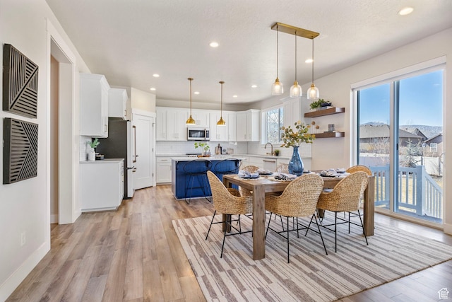 dining room with visible vents, baseboards, a textured ceiling, light wood-type flooring, and recessed lighting
