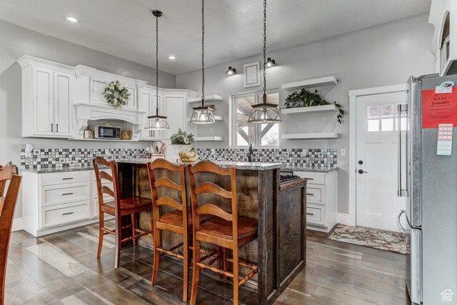 720 S 700 E, Mount Pleasant, UT 84647 - kitchen with a kitchen breakfast bar, a kitchen island, open shelves, freestanding refrigerator, and white cabinetry