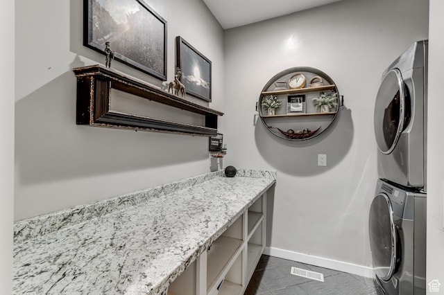 720 S 700 E, Mount Pleasant, UT 84647 - clothes washing area featuring laundry area, stacked washer and dryer, visible vents, baseboards, and dark tile patterned flooring