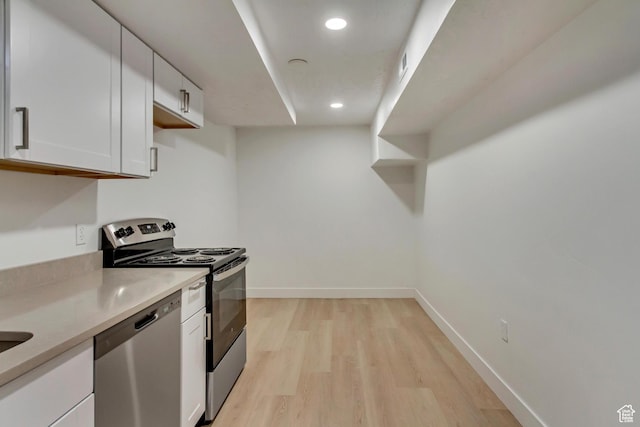 320 S 7 E, Tooele, UT 84074 - kitchen featuring appliances with stainless steel finishes, white cabinets, light wood finished floors, light countertops, and recessed lighting