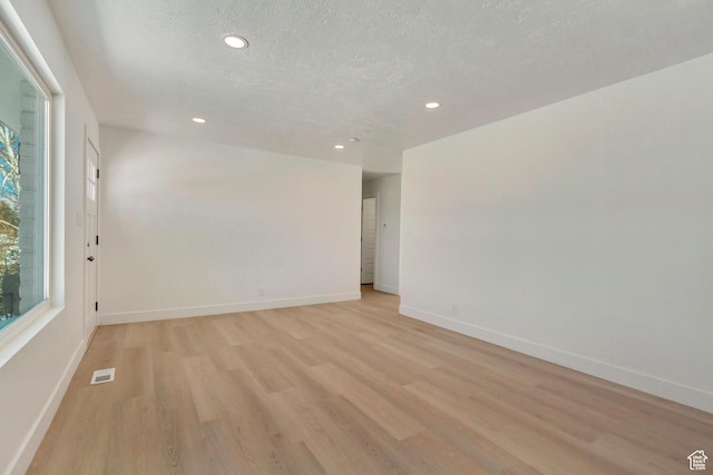 320 S 7 E, Tooele, UT 84074 - unfurnished room with light wood-style floors, baseboards, recessed lighting, and a textured ceiling