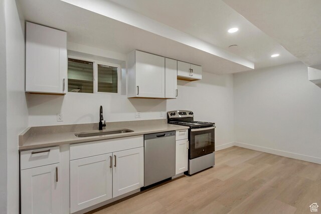 320 S 7 E, Tooele, UT 84074 - kitchen with stainless steel appliances, a sink, white cabinetry, recessed lighting, and light countertops