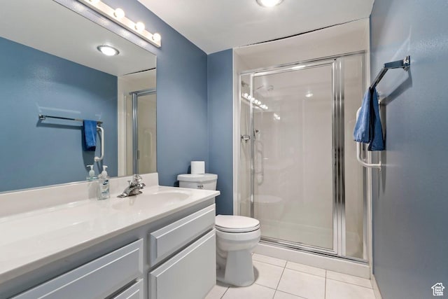 241 N Vine St Unit 1201E, Salt Lake City, UT 84103 - bathroom featuring vanity, a shower with shower door, tile patterned floors, and toilet