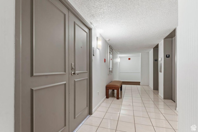 241 N Vine St Unit 1201E, Salt Lake City, UT 84103 - hall with light tile patterned flooring, elevator, and a textured ceiling