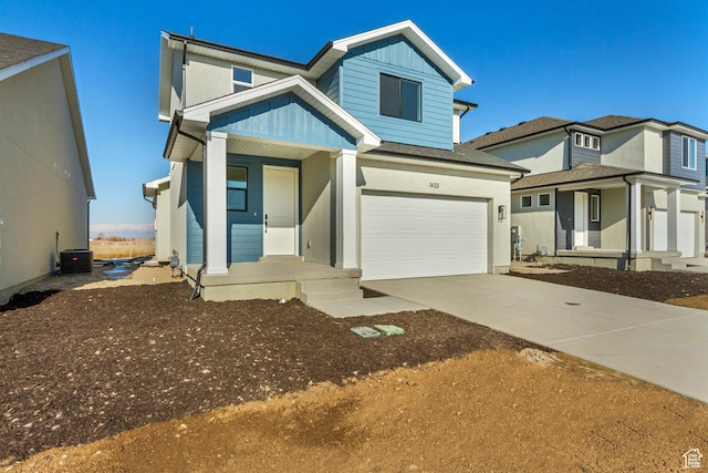 view of front of house with central AC, driveway, board and batten siding, covered porch, and a garage
