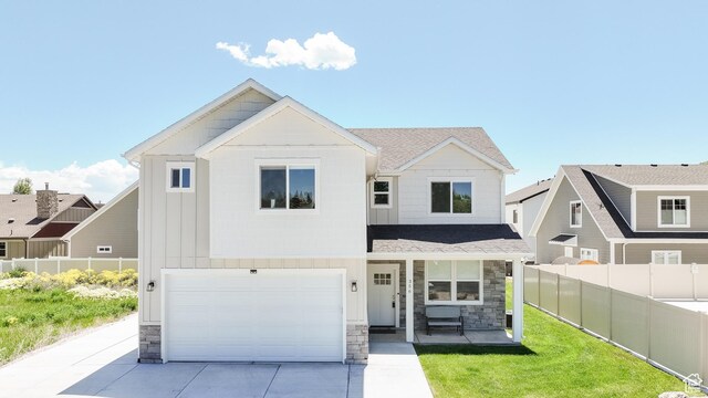 356 W Rendezvous Way, Garden City, UT 84028 - view of front of property featuring stone siding, concrete driveway, and an attached garage