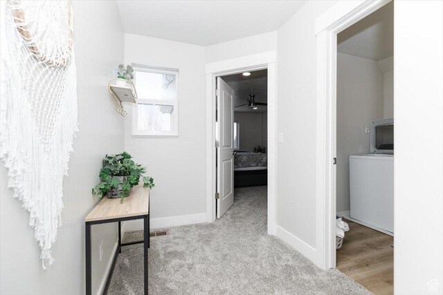 356 W Rendezvous Way, Garden City, UT 84028 - corridor featuring washer / clothes dryer and light carpet