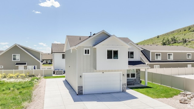 356 W Rendezvous Way, Garden City, UT 84028 - view of front of property featuring a garage, stone siding, board and batten siding, and driveway
