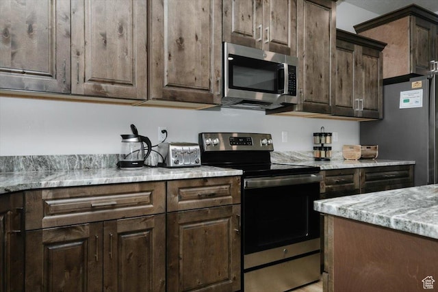 356 W Rendezvous Way, Garden City, UT 84028 - kitchen featuring stainless steel appliances, light stone countertops, and dark brown cabinets