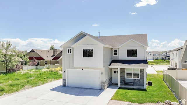 356 W Rendezvous Way, Garden City, UT 84028 - view of front of house featuring stone siding, an attached garage, driveway, and a porch