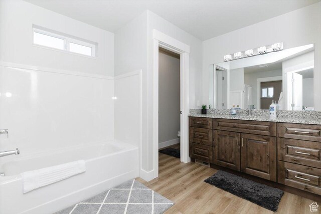 356 W Rendezvous Way, Garden City, UT 84028 - bathroom with vanity, wood-type flooring, a bathing tub, and toilet