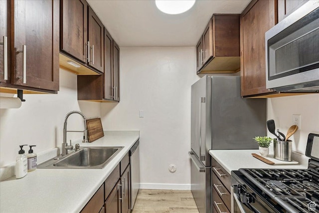 435 E Creekside Cir S Unit A, Salt Lake City, UT 84107 - kitchen with appliances with stainless steel finishes, a sink, light wood finished floors, and light countertops