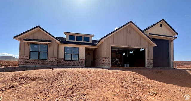 1589 S 4000 W Unit 12, Hurricane, UT 84737 - view of front of property featuring brick siding, board and batten siding, and an attached garage