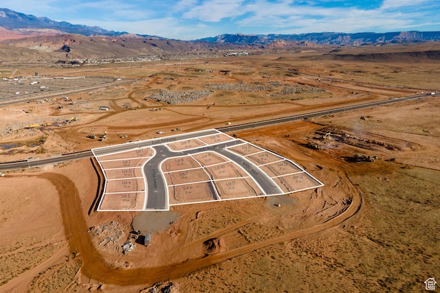1589 S 4000 W Unit 12, Hurricane, UT 84737 - aerial view of sparsely populated area featuring property boundaries highlighted, a mountainous background, and a desert landscape
