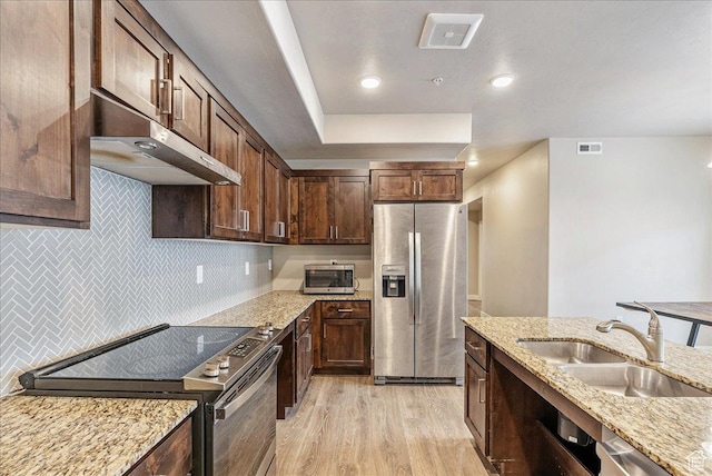 1079 W 420 S Unit 102, American Fork, UT 84003 - kitchen with light stone countertops, appliances with stainless steel finishes, sink, and light wood-type flooring