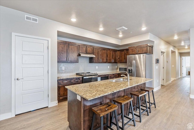 1079 W 420 S Unit 102, American Fork, UT 84003 - kitchen with a kitchen bar, sink, light hardwood / wood-style flooring, stainless steel appliances, and a kitchen island with sink