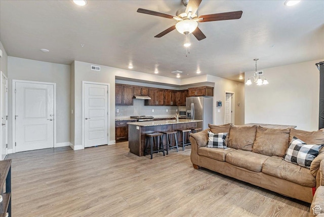 1079 W 420 S Unit 102, American Fork, UT 84003 - living room with sink, ceiling fan with notable chandelier, and light hardwood / wood-style floors