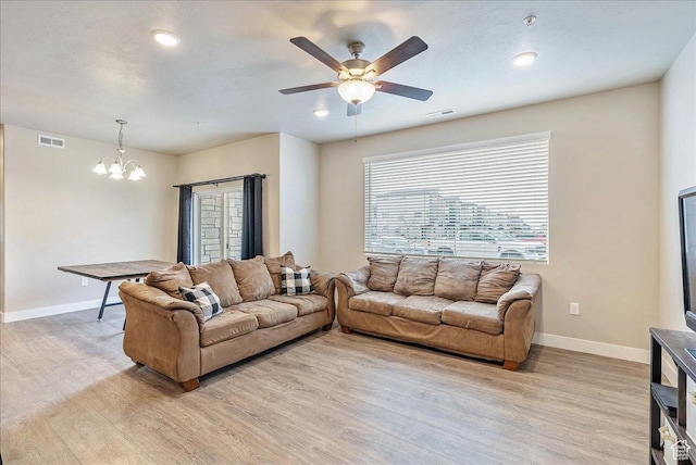 1079 W 420 S Unit 102, American Fork, UT 84003 - living room featuring ceiling fan with notable chandelier and light wood-type flooring