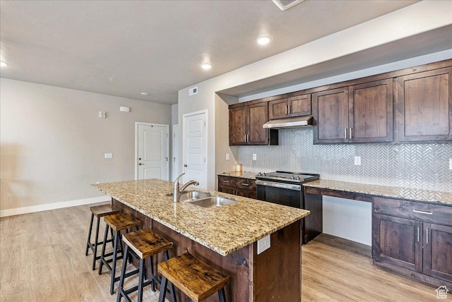 1079 W 420 S Unit 102, American Fork, UT 84003 - kitchen featuring light stone counters, sink, a breakfast bar, and a kitchen island with sink