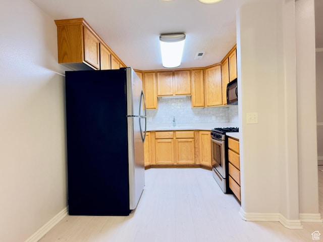 1444 S 430 W Unit 7, Orem, UT 84058 - kitchen with appliances with stainless steel finishes, tasteful backsplash, light countertops, and light wood finished floors