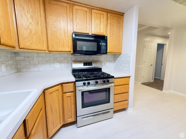 1444 S 430 W Unit 7, Orem, UT 84058 - kitchen featuring black microwave, stainless steel gas range, tasteful backsplash, and light countertops