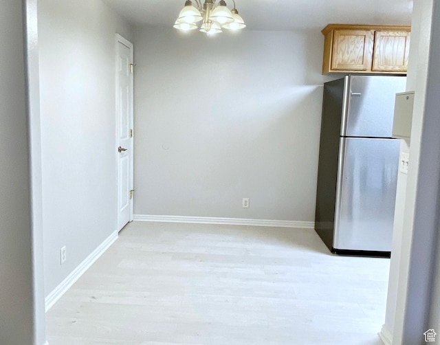 1444 S 430 W Unit 7, Orem, UT 84058 - kitchen with a notable chandelier, stainless steel refrigerator, and light hardwood / wood-style floors