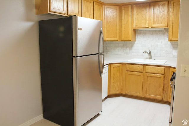 1444 S 430 W Unit 7, Orem, UT 84058 - kitchen featuring stainless steel appliances, sink, light hardwood / wood-style flooring, and backsplash