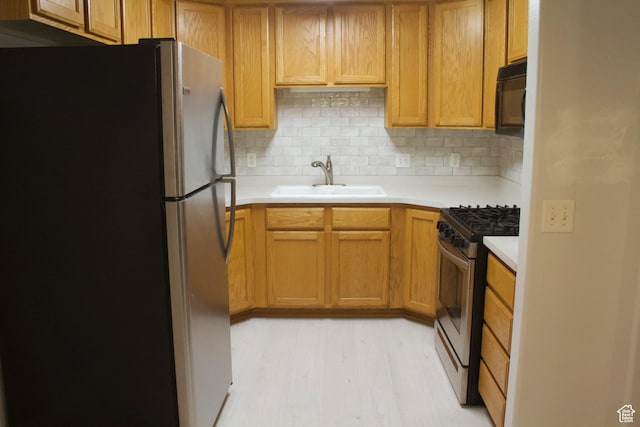 1444 S 430 W Unit 7, Orem, UT 84058 - kitchen with tasteful backsplash, stainless steel appliances, light hardwood / wood-style floors, and sink
