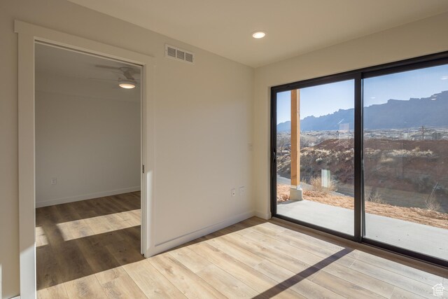 1185 S Murphy Ln Unit 201A, Moab, UT 84532 - empty room featuring a mountain view, wood finished floors, recessed lighting, and baseboards