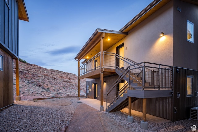 1185 S Murphy Ln Unit 201A, Moab, UT 84532 - view of home's exterior with stairs, stucco siding, a balcony, a mountain view, and a patio area