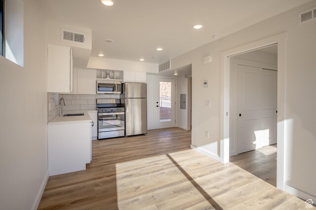 1185 S Murphy Ln Unit 201A, Moab, UT 84532 - kitchen featuring appliances with stainless steel finishes, a sink, light countertops, white cabinetry, and light wood-style floors