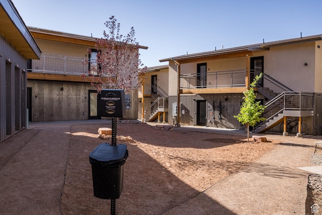 1185 S Murphy Ln Unit 201A, Moab, UT 84532 - back of property featuring stairway and stucco siding