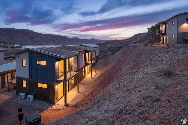 1185 S Murphy Ln Unit 201A, Moab, UT 84532 - view of front of property featuring board and batten siding, a mountain view, and a balcony