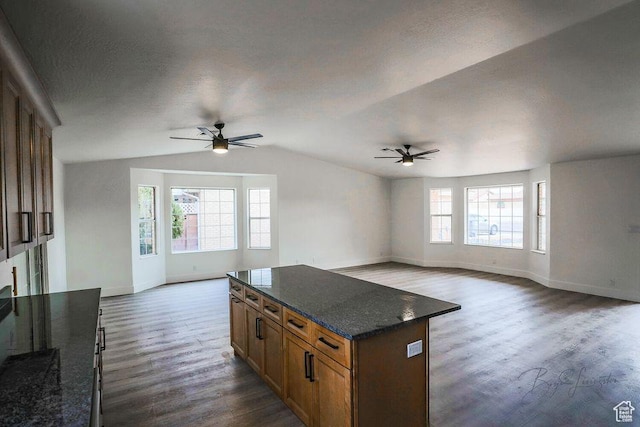 696 N Westridge Dr W Unit 2, St George, UT 84770 - kitchen with a kitchen island, dark hardwood / wood-style floors, dark stone countertops, and ceiling fan