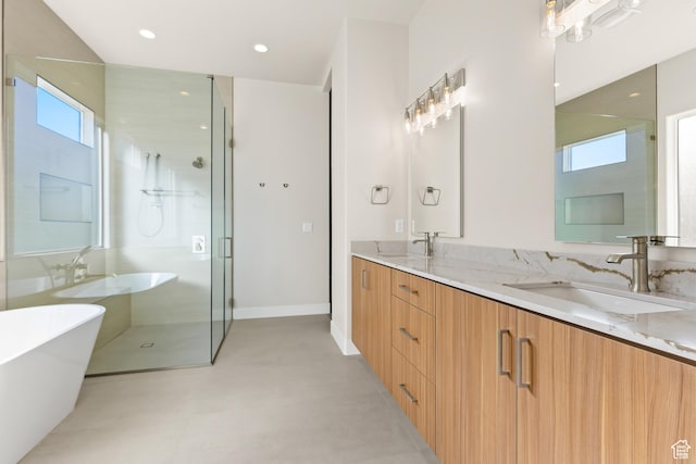 full bathroom with double vanity, a freestanding tub, recessed lighting, a stall shower, and a sink