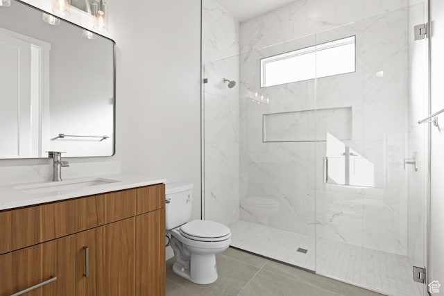 full bath with vanity, toilet, tile patterned flooring, and a marble finish shower