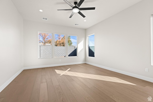 empty room featuring hardwood / wood-style floors, recessed lighting, baseboards, and a ceiling fan