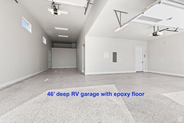 garage featuring electric panel, baseboards, and a garage door opener