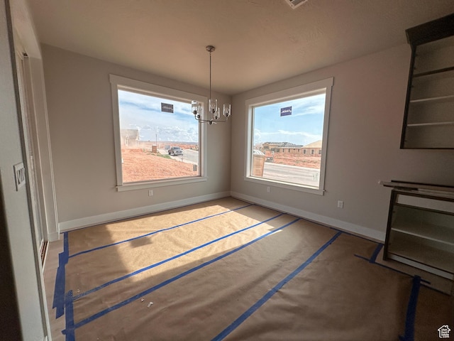 3997 W 1500 S, Hurricane, UT 84737 - unfurnished dining area with baseboards and a chandelier
