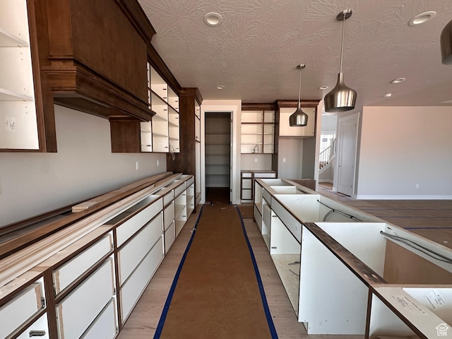 3997 W 1500 S, Hurricane, UT 84737 - kitchen with decorative light fixtures, recessed lighting, white cabinetry, a textured ceiling, and light wood-style flooring