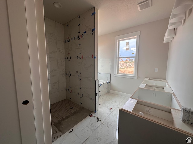 3997 W 1500 S, Hurricane, UT 84737 - bathroom featuring marble look tiles, double vanity, and a shower stall