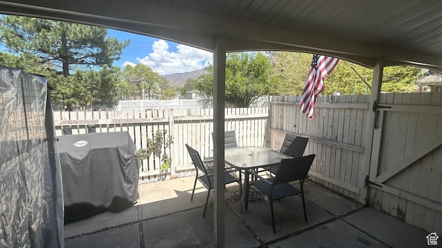 271 Brookfield Ln, Centerville, UT 84014 - view of patio / terrace with outdoor dining area, a fenced backyard, a mountain view, and a grill