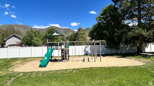 271 Brookfield Ln, Centerville, UT 84014 - view of play area featuring a lawn, fence, and a mountain view