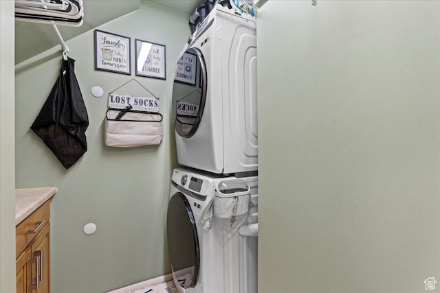 271 Brookfield Ln, Centerville, UT 84014 - washroom with cabinet space and stacked washer and dryer