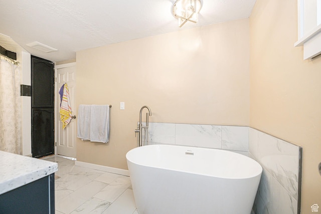41 N Center St, Wellsville, UT 84339 - bathroom featuring vanity, a textured ceiling, and a bathtub